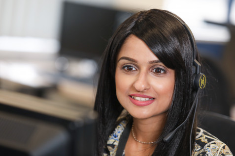 A woman in a call centre wearing a telephone headset